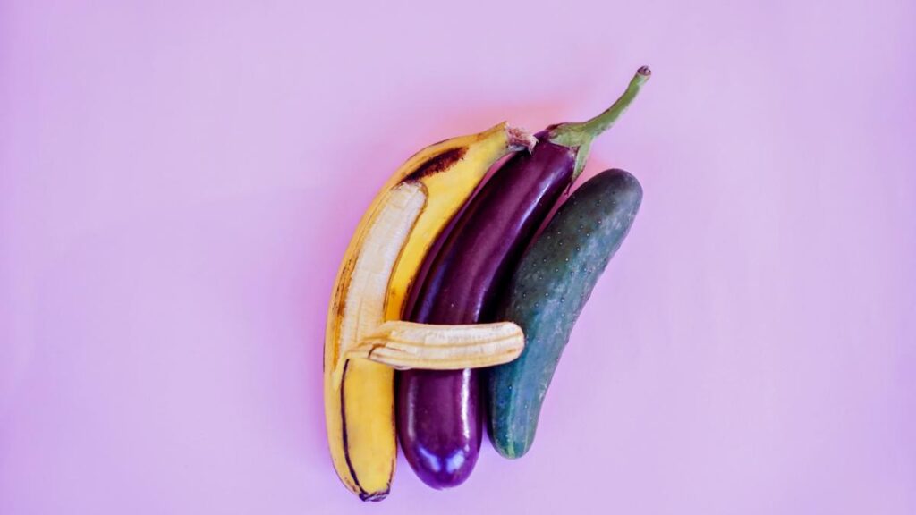 a banana spooning an eggplant that is spooning a zucchini 